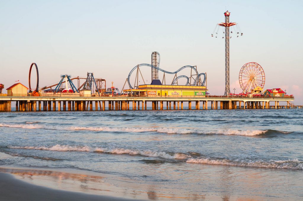 Views of historic Pleasure Pier in Galveston from the beach