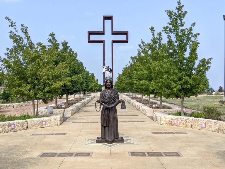 Large empty cross at the Coming King Sculpture Prayer Garden in Kerrville Texas